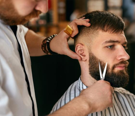 Barbering man at hairdresser