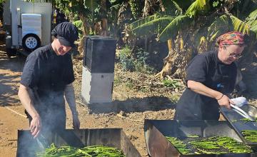 Seth Schleicher and Lucinda Jose grilling asparagus in a Carnarvon plantation